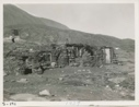Image of Typical West Greenland home, Rock and Sod home. Miriam walking in back